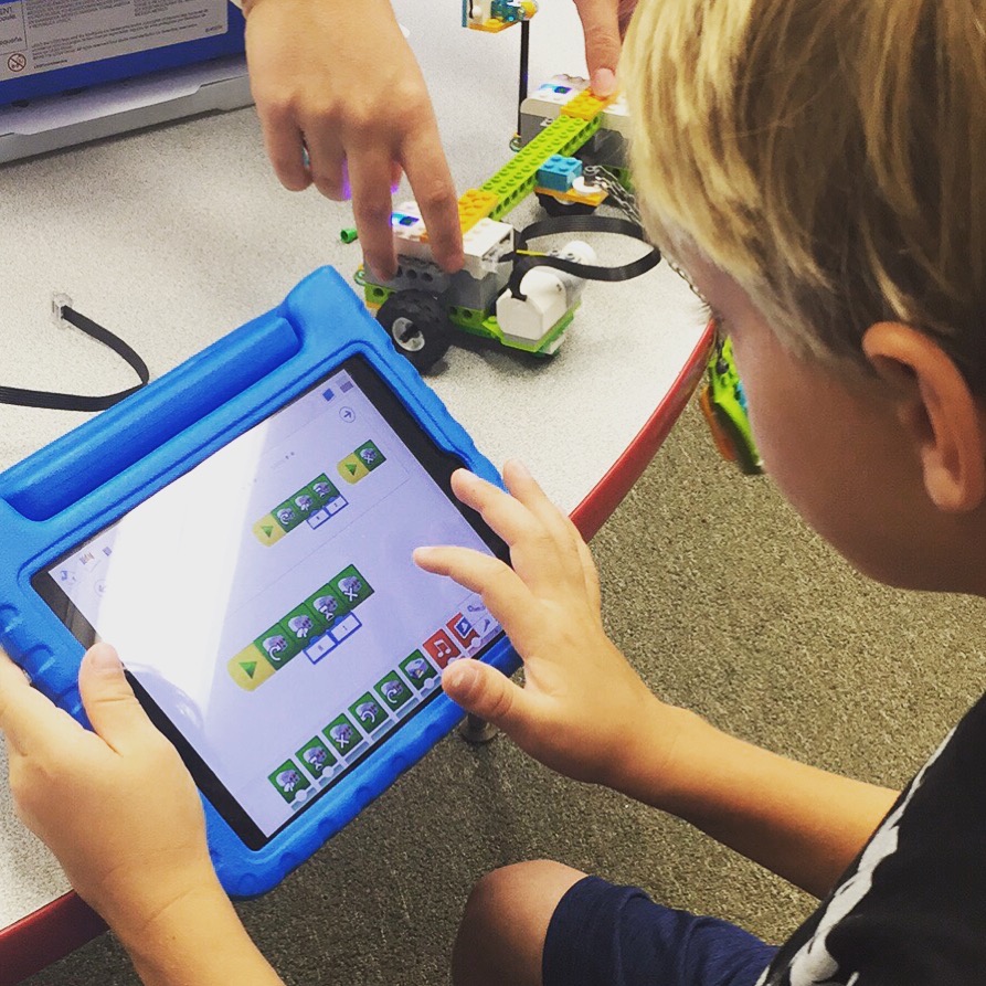 Elementary school student learns programming and coding with iPads and WeDo LEGO kits in Long Beach