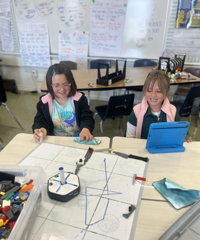 Elementary school students learn programming and coding with iPads and Root iRobots in Long Beach