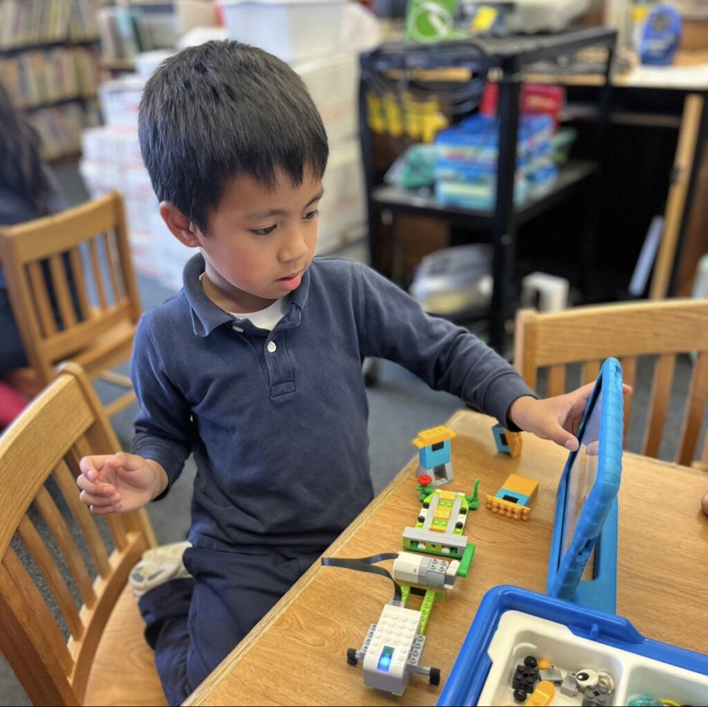 Elementary school student practices engineering with LEGOs in Long Beach